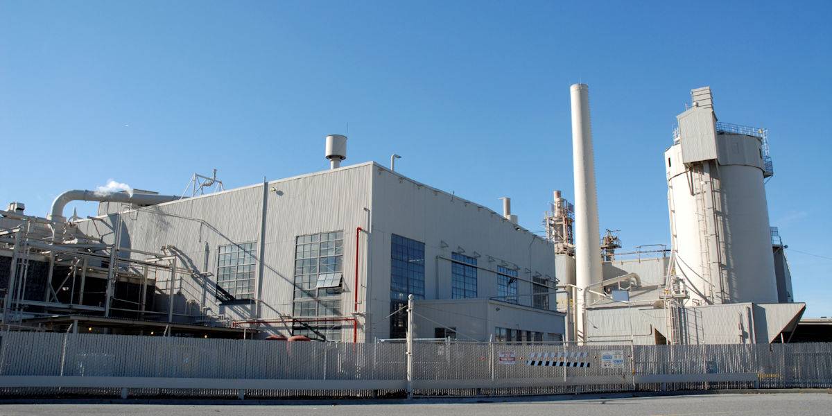 outside of a power plant with several silos attached