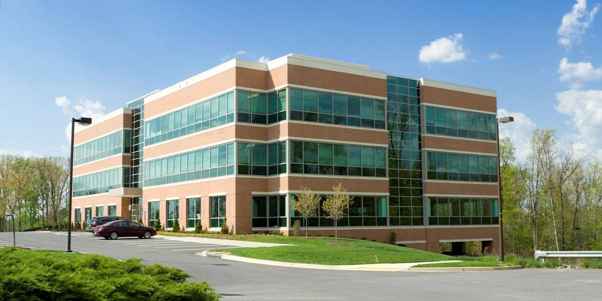 large three story office building with windows on every floor